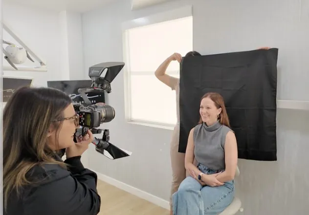 Dr. Andi-Jean Miro taking smile design photographs of a patient before porcelain veneers